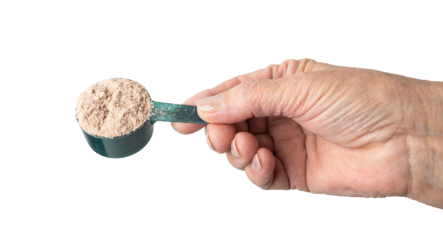 Senior female hand holding a portion of whey protein powder in a measuring spoon, isolated on a transparent background