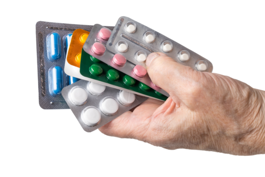 Senior female hand holding various blister packs of prescription medication, antibiotic pills, painkiller capsules, isolated on a transparent background. Healthcare, elderly care, medical treatment