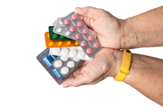 Senior female hand holding various blister packs of prescription medication, antibiotic pills, painkiller capsules, isolated on a transparent background. Healthcare, elderly care, medical treatment