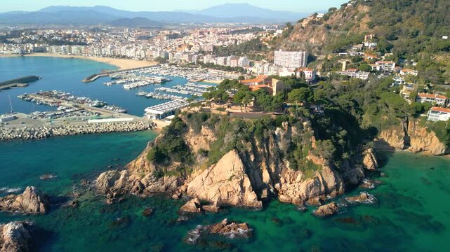 Blanes breathtaking aerial perspective of blanes, showcasing the iconic sa palomera rock and the vibrant port on the costa brava