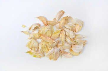 Crushed garlic cloves on white background close up, top view.