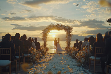 Sunset Wedding Ceremony: A romantic sunset wedding ceremony takes place on a picturesque waterfront, with the couple standing under an elegant floral archway, bathed in golden sunlight.