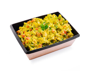 Fresh guacamole with diced vegetables served in a black container highlighting vibrant colors and textures