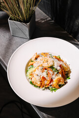 Delicious shrimp pasta dish served in a stylish restaurant setting with fresh ingredients