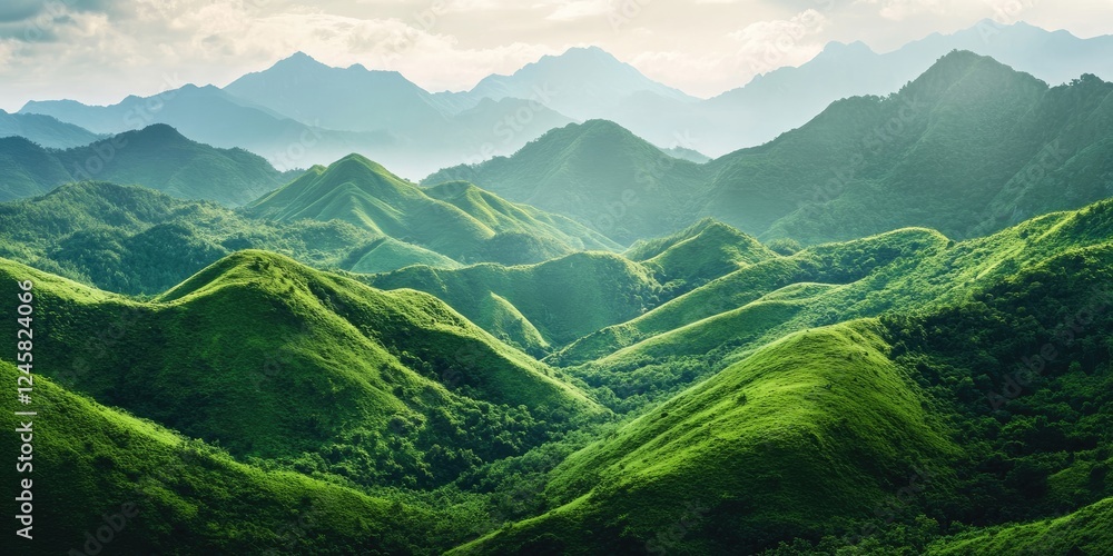 Aufkleber lush green mountain range with rolling hills in bright green tones under a soft cloudy sky providing
