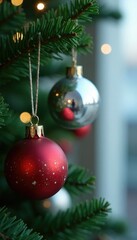 Fototapeta premium Twinkling silver blue gold ornaments hang from a lush green garland, red, silver