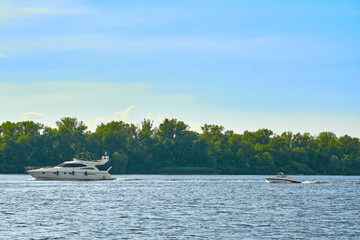 Sunny summer warm river and pleasure boats and yachts