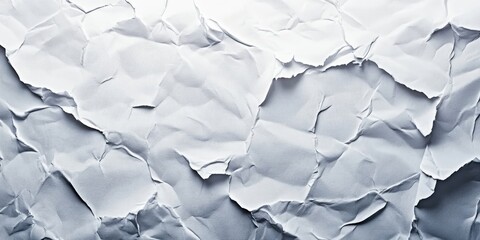 Obraz premium Crumpled gray paper texture with varying shades and creases creating a three-dimensional effect ideal for backgrounds or overlays