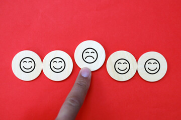 Hands menolak angry facial emotions because of toxic. review, satisfaction and feedback concepts