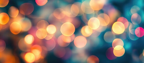 Fototapeta premium Colorful bokeh lights background creating a beautiful out of focus abstract pattern for festive or artistic themes