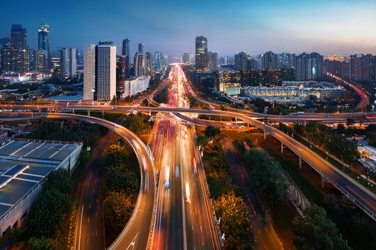 Top view traffic jams in big city at night. Royalty high-quality free best stock of city street with multiple lanes filled with cars, all stopped, moving slowly due to traffic congestion in twilight