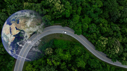 Aerial view EV electric vehicle car on middle green tree forest road globe earth planet, EV car electric vehicle car alternative sustainable energy eco power, Green business ecosystem environment.
