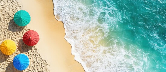 Vibrant sandy beach with colorful umbrellas and gentle waves ideal for summer vacation themes and promotional materials