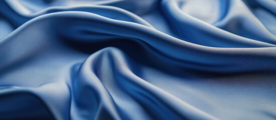 Obraz premium Elegant blue satin fabric drape providing a soft background ideal for photography and videography with smooth texture and vibrant color.