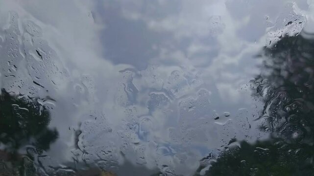 Watching the rain through the glass window.