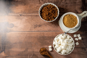 Light brown, dark brown and white sugar cubes in bowls. Different type of sugar