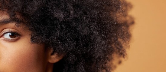 Dry 4c Type afro curly hair characterized by shrinkage against a warm brown background showcasing natural texture and beauty.