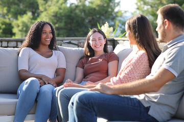 Four friends talking in a terrace