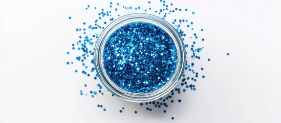 Blue glitter in transparent jar on white background top view for festive themes and color inspiration 2020 concept