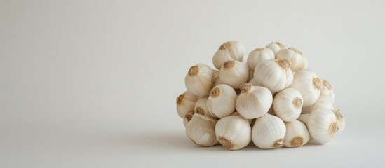 Fresh harvested garlic bulbs arranged together on a clean white background showcasing their texture and natural color.