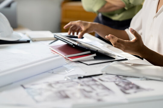 Architects interior designer hands working with Blueprints and documents for a home renovation for house design.