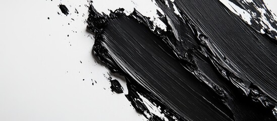 Bold black oil paint brushstrokes on a pristine white background creating a striking artistic contrast and texture for creative projects