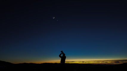 Amateur astronomer looking at the evening skies, observing planets, stars, Moon and other celestial...
