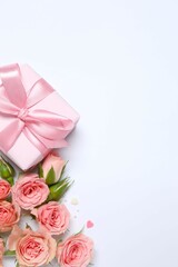 Beautiful composition with pink roses and gift box on color background