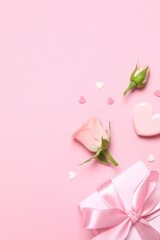 Beautiful composition with gift box and pink roses on color background