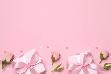 Beautiful composition with gift boxes and pink roses on color background