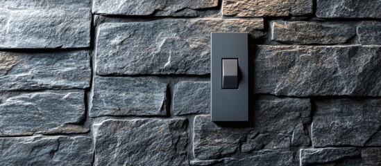 Gray light switch on textured stone wall background emphasizing modern design and home decor elements