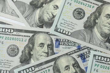 Money, hundred dollar background pattern on wooden background. Money is scattered on the table....