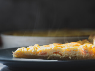 Hot, steaming portion of a quiche lorraine. typical dish of French cuisine