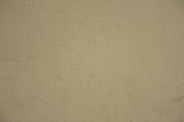 Close up of old and dirty beige painted wall