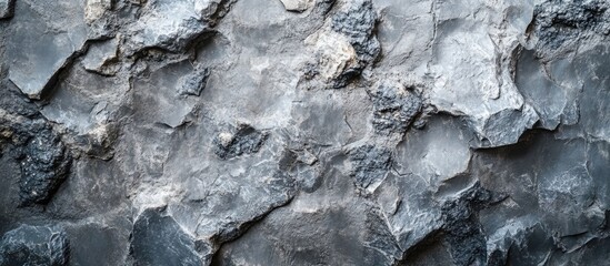 Gray rough concrete wall texture background with intricate patterns and details for design and architectural use.