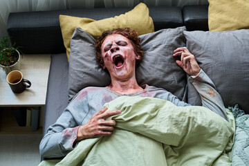Young Male Zombie Waking Up In Morning