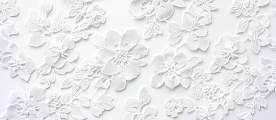 Elegant white lace fabric with intricate floral design arranged on a clean white background for textile or design applications