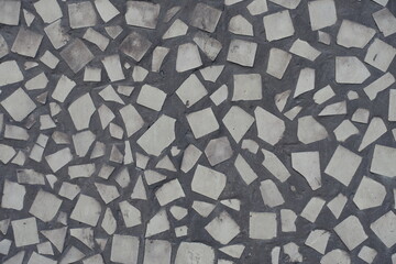 Dusty surface of old pale beige mosaic wall