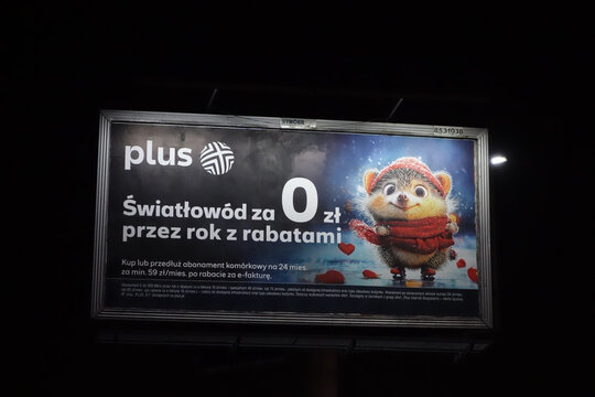 Kielce, Świętokrzyskie, Poland - February, 5-2025: Advertising billboard plus, fiber optic internet - night view.