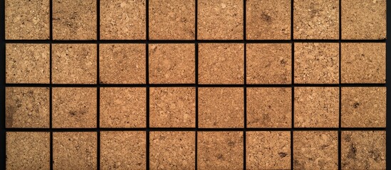 Natural cork texture placemat with a black grid pattern featuring empty squares ideal for scheduling and reminder messages.