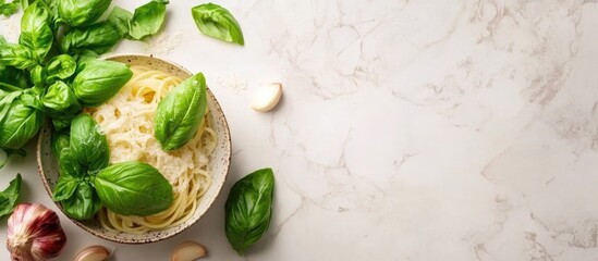 Fresh spaghetti garnished with basil and garlic on marble surface with empty space for customizable text or marketing content