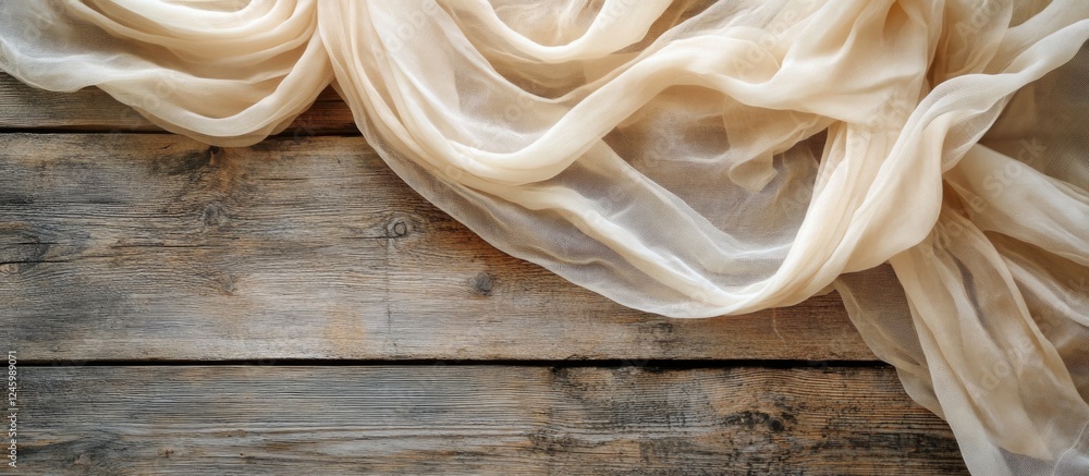Poster beige gauze fabric draped on rustic wooden tabletop for elegant event decoration with ample copy spa