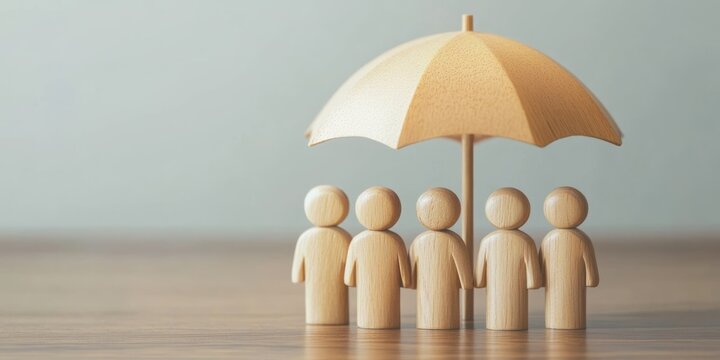 Employee protection and financial security concept with wooden figures under umbrella representing insurance and investment strategies