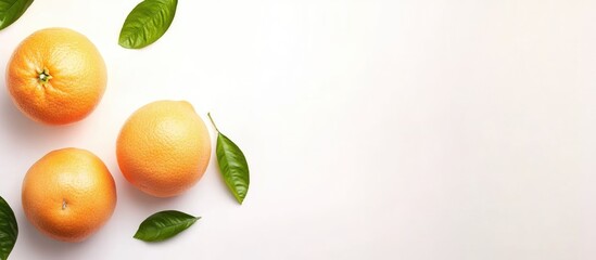 Fresh Grapefruit and Leaves on a White Background Ideal for Health and Wellness Promotions or Text Additions