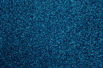 Blue glitter foil Christmas background. Shiny metal blue foil texture abstract defocused...