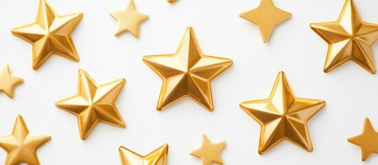 Obraz premium Golden stars and decorative ribbons arranged on a white background with ample empty space for personalized text or messages.