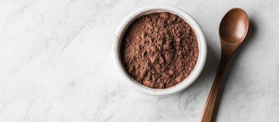 Gelatin powder in white bowl with wooden spoon on light grey marble table top view for cooking or baking ingredients concepts