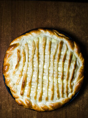 A pie with lattice crust on a wooden table