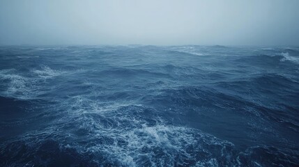 Fototapeta premium A Vast and Wavy Ocean View with Misty Horizon, showing the movement of water