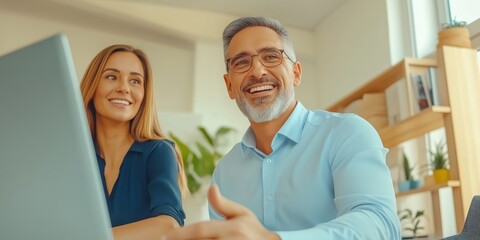 Obraz premium Young Professionals Discussing Ideas with Tablet in Modern Office Setting